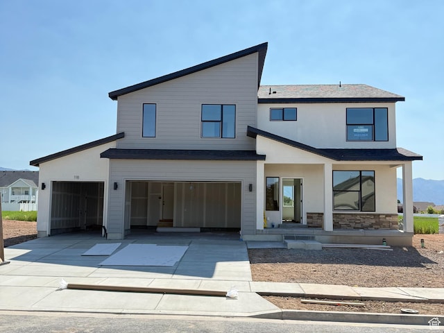 118 N 825 W, Clearfield, UT 84015 - view of front of property featuring concrete driveway, roof with shingles, stone siding, and an attached garage