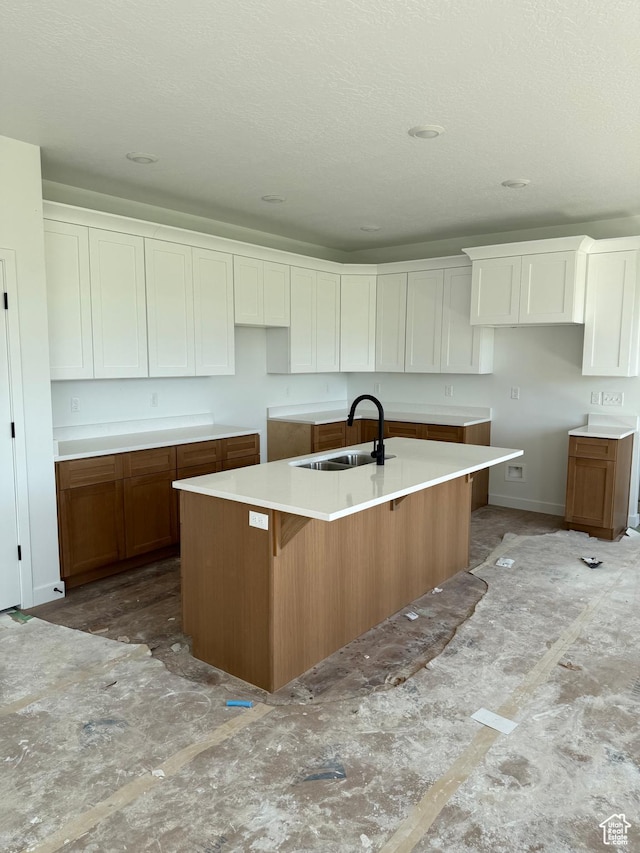 118 N 825 W, Clearfield, UT 84015 - kitchen featuring a kitchen island with sink, white cabinetry, and brown cabinets