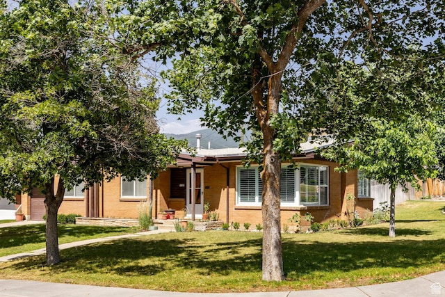 1795 S 50 W, Bountiful, UT 84010 - view of front of property with brick siding, a front lawn, and a garage