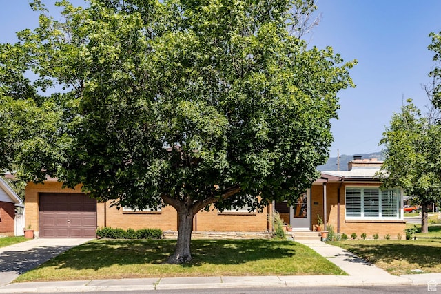1795 S 50 W, Bountiful, UT 84010 - obstructed view of property featuring driveway, brick siding, a front lawn, and an attached garage