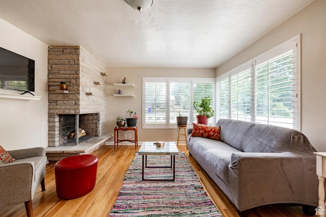 1795 S 50 W, Bountiful, UT 84010 - living room with plenty of natural light, wood finished floors, a textured ceiling, and a stone fireplace