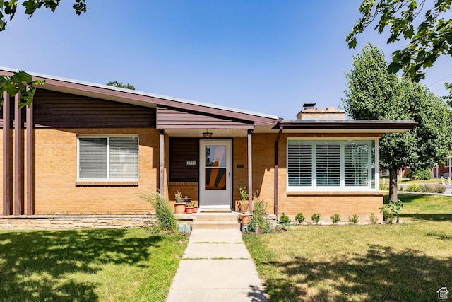 1795 S 50 W, Bountiful, UT 84010 - view of front of home featuring brick siding, a front lawn, and a chimney