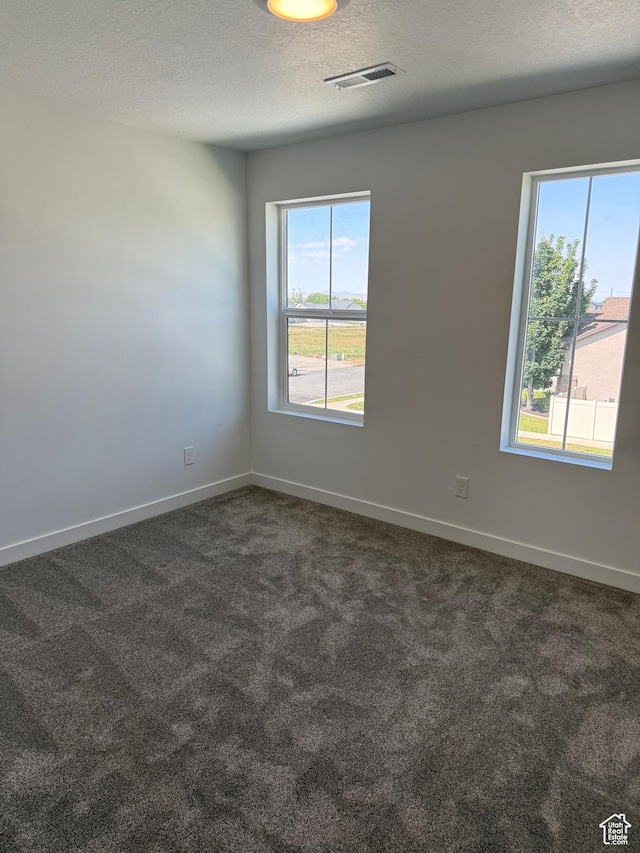 274 N 825 W, Clearfield, UT 84015 - spare room with dark colored carpet and a textured ceiling