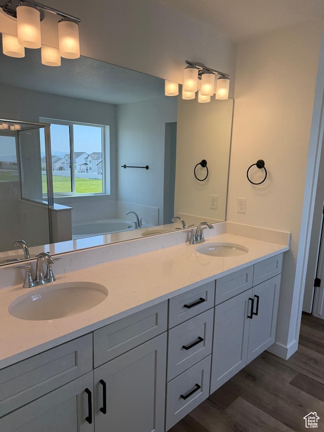 274 N 825 W, Clearfield, UT 84015 - bathroom featuring double vanity, wood finished floors, and a bath