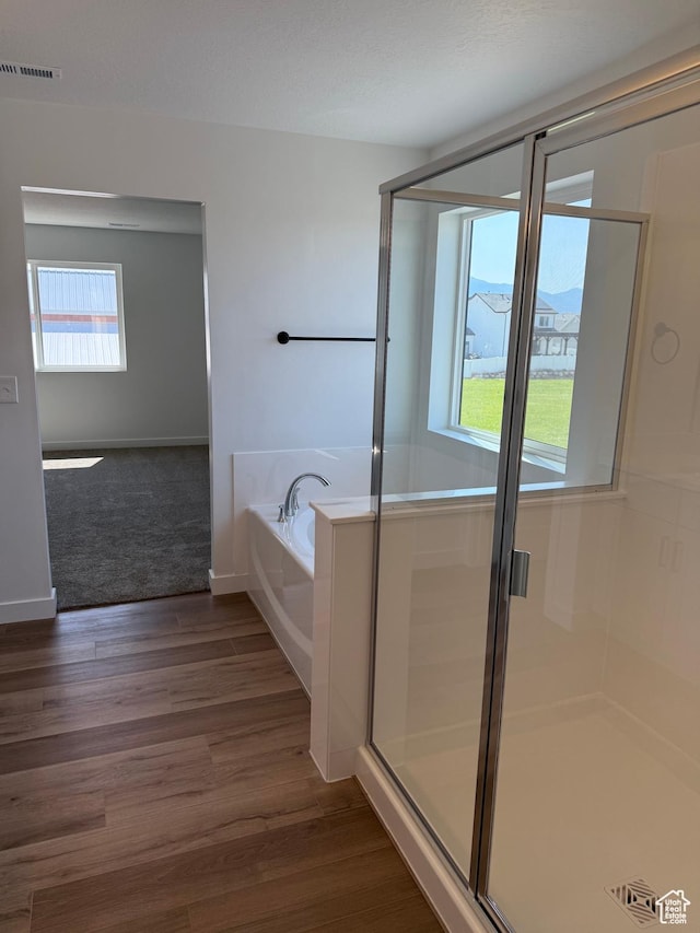 274 N 825 W, Clearfield, UT 84015 - bathroom featuring a garden tub, a shower stall, and wood finished floors