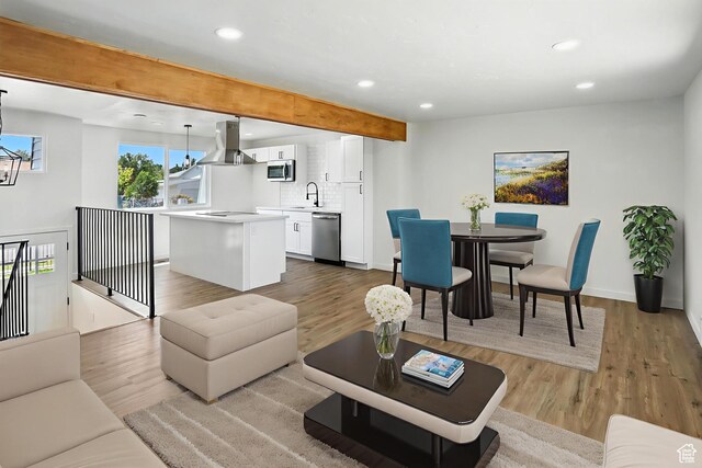 1202 Tamarack Rd, Taylorsville, UT 84123 - living room featuring recessed lighting, light wood-style floors, beam ceiling, and a chandelier