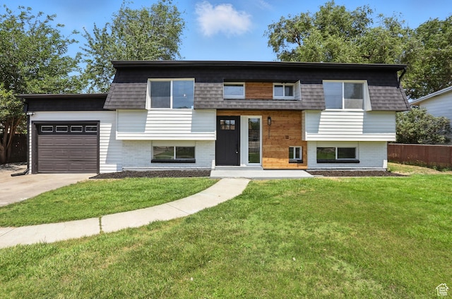 1202 Tamarack Rd, Taylorsville, UT 84123 - view of front facade featuring an attached garage, driveway, and brick siding