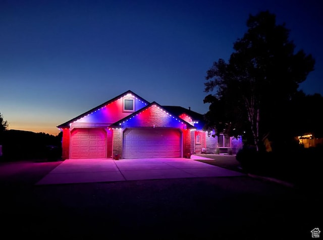 3520 W 2600 N, Plain City, UT 84404 - view of front facade with driveway, an attached garage, and stone siding