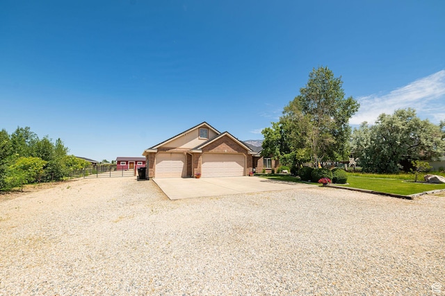 3520 W 2600 N, Plain City, UT 84404 - view of front of house featuring driveway, an attached garage, and brick siding