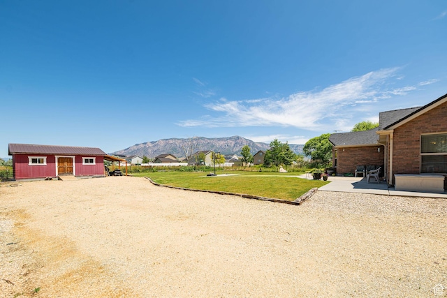 3520 W 2600 N, Plain City, UT 84404 - view of grassy yard featuring a mountain view and a patio area