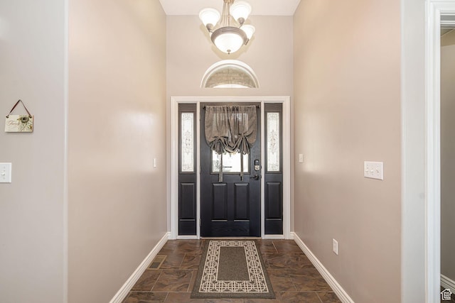 3520 W 2600 N, Plain City, UT 84404 - entrance foyer featuring dark stone finish flooring, a chandelier, and a towering ceiling
