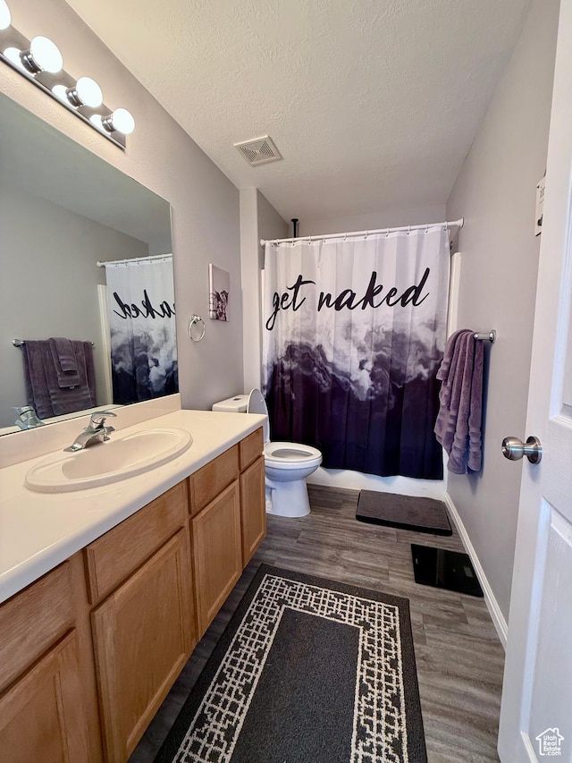 7089 S Brittany Town Dr, West Jordan, UT 84084 - full bathroom with vanity, wood finished floors, a textured ceiling, and curtained shower