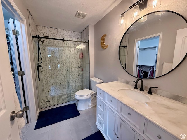 7089 S Brittany Town Dr, West Jordan, UT 84084 - full bathroom with a spacious closet, vanity, tile patterned flooring, a shower stall, and a textured ceiling