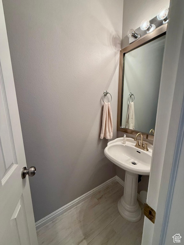7089 S Brittany Town Dr, West Jordan, UT 84084 - bathroom featuring wood finished floors and baseboards