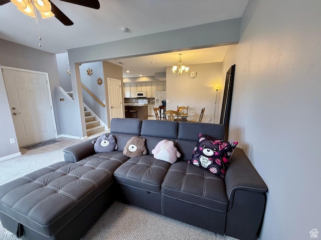 7089 S Brittany Town Dr, West Jordan, UT 84084 - living room with stairs, a chandelier, a ceiling fan, and light colored carpet