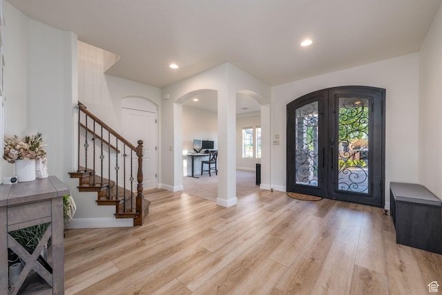 2979 E 3610th Cir S, St George, UT 84790 - foyer featuring french doors, arched walkways, light wood-style floors, stairs, and recessed lighting