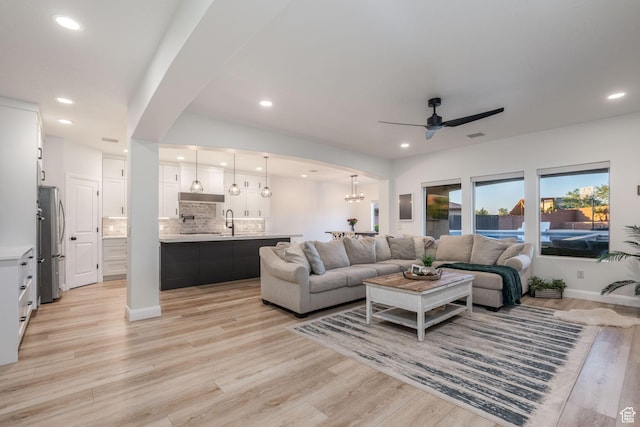 2979 E 3610th Cir S, St George, UT 84790 - living area with ceiling fan, recessed lighting, light wood-type flooring, arched walkways, and a chandelier