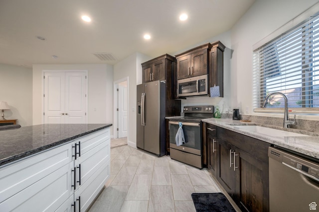 2979 E 3610th Cir S, St George, UT 84790 - kitchen featuring stainless steel appliances, dark brown cabinets, dark stone countertops, and recessed lighting