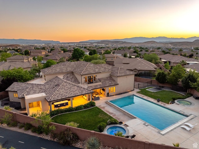 2979 E 3610th Cir S, St George, UT 84790 - pool at dusk with an in-ground hot tub, a fenced backyard, and a mountain view