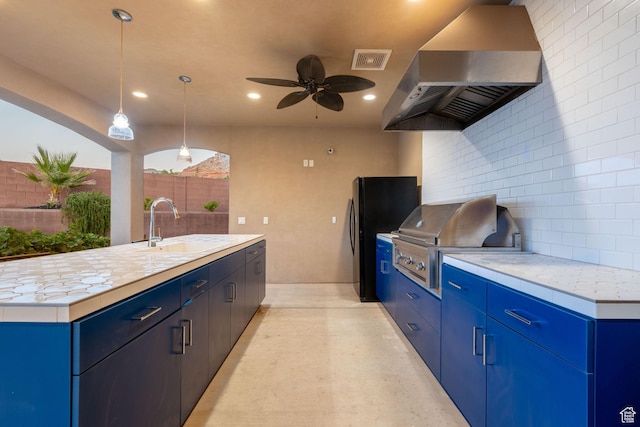 2979 E 3610th Cir S, St George, UT 84790 - kitchen featuring wall chimney range hood, blue cabinets, backsplash, light countertops, and recessed lighting