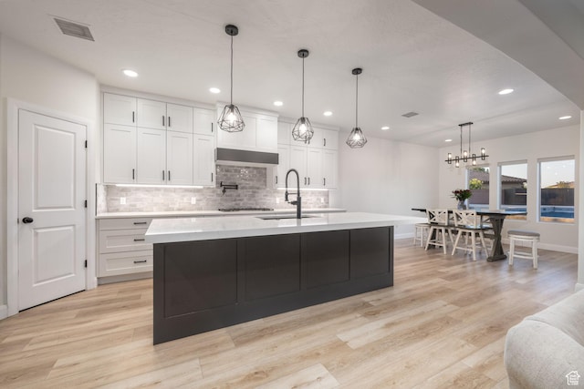 2979 E 3610th Cir S, St George, UT 84790 - kitchen with light countertops, decorative backsplash, light wood finished floors, and recessed lighting