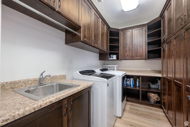 2979 E 3610th Cir S, St George, UT 84790 - washroom with washer and clothes dryer, cabinet space, and light wood-style flooring