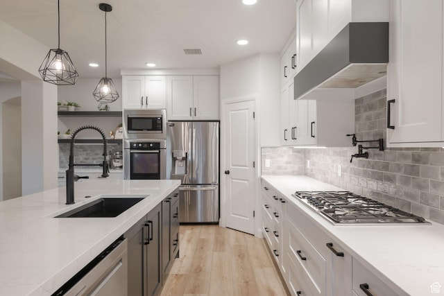 2979 E 3610th Cir S, St George, UT 84790 - kitchen with appliances with stainless steel finishes, wall chimney exhaust hood, white cabinets, and recessed lighting