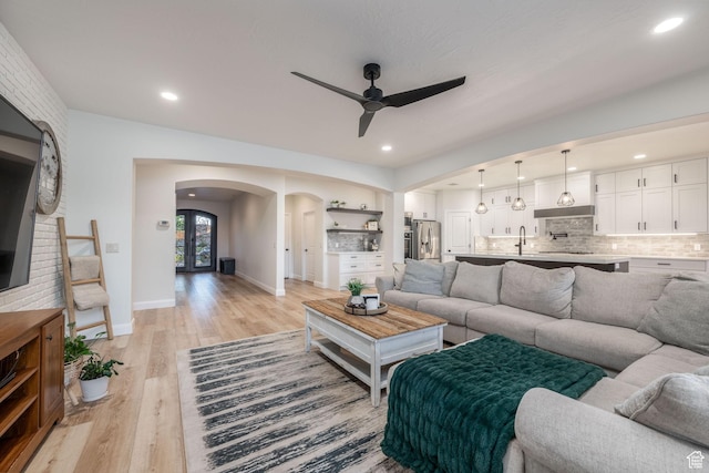 2979 E 3610th Cir S, St George, UT 84790 - living area with arched walkways, ceiling fan, light wood-style flooring, and recessed lighting