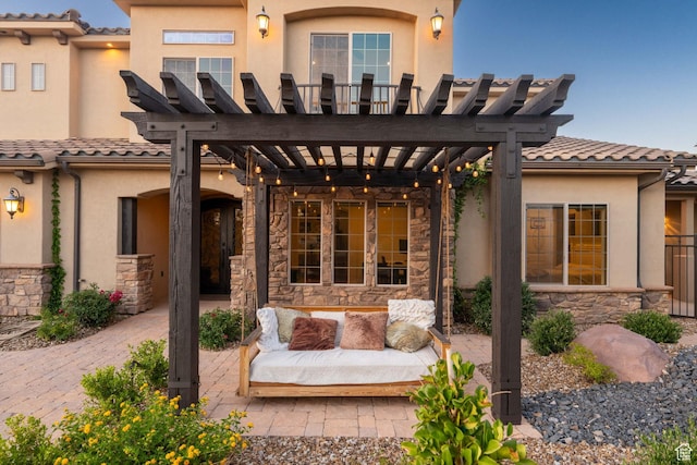 2979 E 3610th Cir S, St George, UT 84790 - rear view of house with a pergola, stone siding, stucco siding, a tile roof, and a patio area