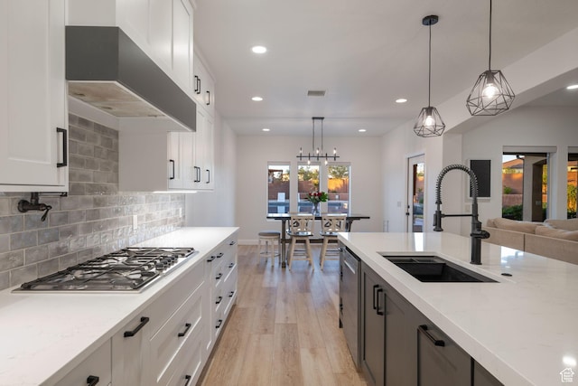2979 E 3610th Cir S, St George, UT 84790 - kitchen featuring appliances with stainless steel finishes, wall chimney range hood, light wood finished floors, recessed lighting, and backsplash