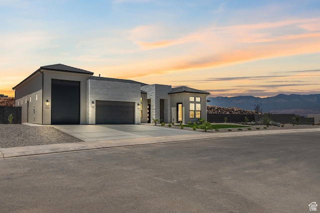794 S 1690 W, Hurricane, UT 84737 - modern home featuring an attached garage, a mountain view, concrete driveway, and stucco siding