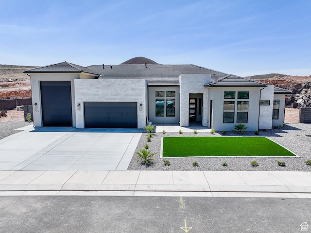 794 S 1690 W, Hurricane, UT 84737 - contemporary house featuring an attached garage, concrete driveway, a front yard, and stucco siding