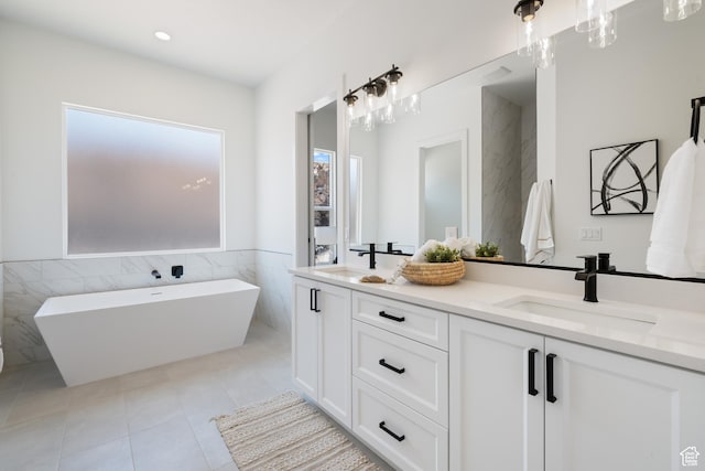 794 S 1690 W, Hurricane, UT 84737 - full bath with tile walls, double vanity, a freestanding tub, tile patterned floors, and a wainscoted wall