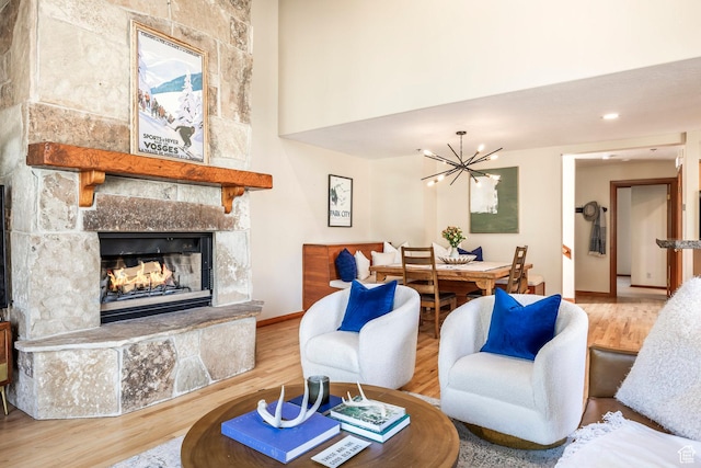 7560 Ridge Dr Unit 10, Park City, UT 84060 - living room featuring a stone fireplace, a chandelier, wood finished floors, and a high ceiling