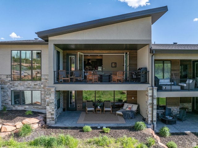 11422 N Vantage Ln Unit 69, Hideout, UT 84036 - rear view of house with stone siding, a patio area, a balcony, and stucco siding
