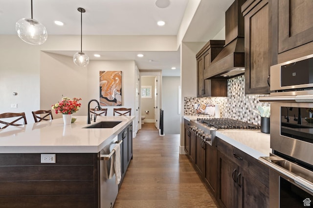 11422 N Vantage Ln Unit 69, Hideout, UT 84036 - kitchen with appliances with stainless steel finishes, dark brown cabinets, light countertops, light wood-type flooring, and recessed lighting