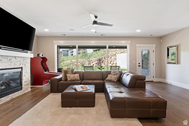 11422 N Vantage Ln Unit 69, Hideout, UT 84036 - living area with plenty of natural light, wood finished floors, a stone fireplace, ceiling fan, and recessed lighting