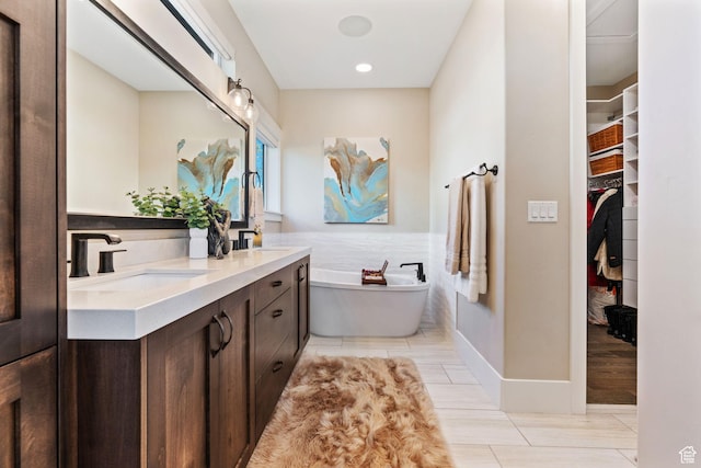 11422 N Vantage Ln Unit 69, Hideout, UT 84036 - bathroom featuring double vanity, a soaking tub, a spacious closet, tile patterned floors, and recessed lighting
