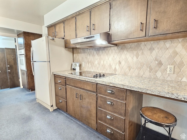 1425 W Main St, Vernal, UT 84078 - kitchen with under cabinet range hood, light carpet, white appliances, and tasteful backsplash