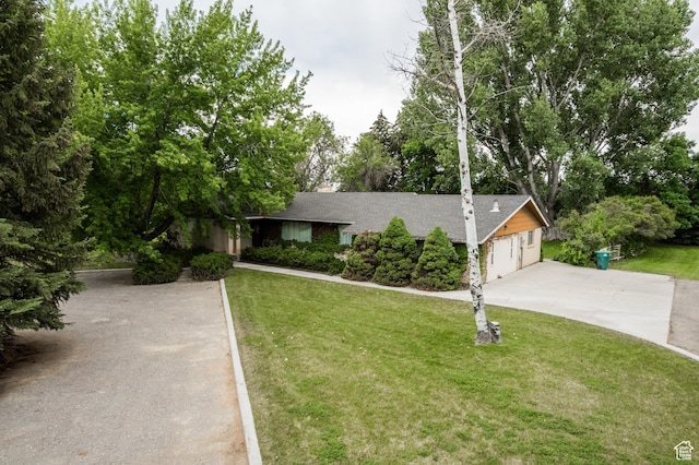 1425 W Main St, Vernal, UT 84078 - view of front facade with a front yard, concrete driveway, roof with shingles, and view of scattered trees