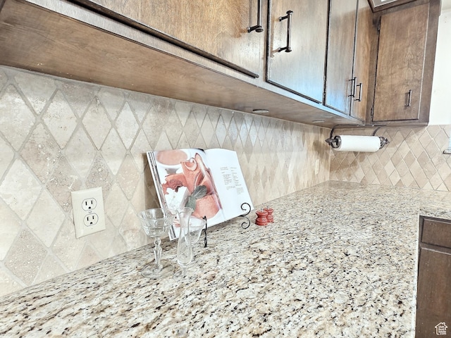 1425 W Main St, Vernal, UT 84078 - kitchen view of tasteful backsplash, light stone countertops, and dark brown cabinetry