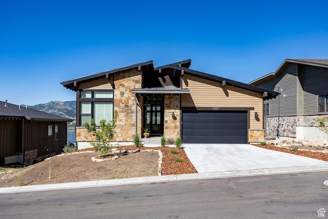 11795 N Star Gazer Cir, Hideout, UT 84036 - view of front of property featuring stone siding, a garage, concrete driveway, and a mountain view