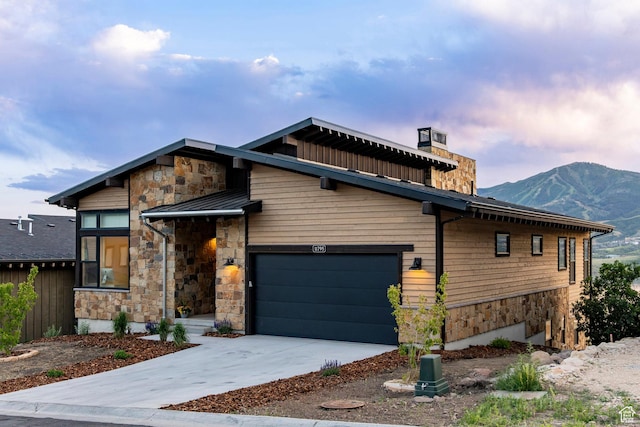 11795 N Star Gazer Cir, Hideout, UT 84036 - contemporary home with stone siding, a standing seam roof, a mountain view, and driveway