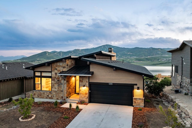 11795 N Star Gazer Cir, Hideout, UT 84036 - modern home featuring stone siding, a mountain view, a chimney, and concrete driveway