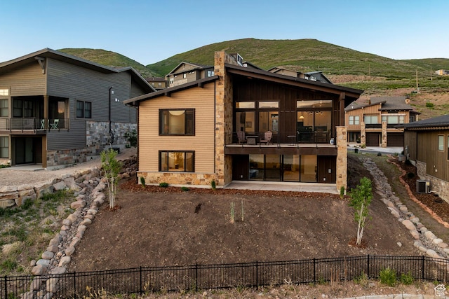 11795 N Star Gazer Cir, Hideout, UT 84036 - back of house featuring a mountain view, stone siding, and a balcony