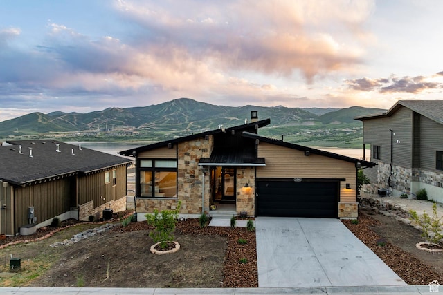 11795 N Star Gazer Cir, Hideout, UT 84036 - contemporary house featuring stone siding, a mountain view, and an attached garage