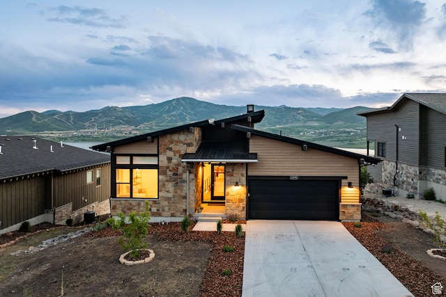 11795 N Star Gazer Cir, Hideout, UT 84036 - modern home featuring stone siding, a mountain view, an attached garage, and driveway