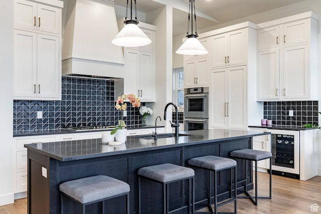 11795 N Star Gazer Cir, Hideout, UT 84036 - kitchen with wine cooler, double oven, a kitchen bar, premium range hood, and backsplash