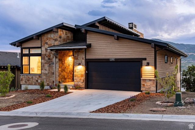 11795 N Star Gazer Cir, Hideout, UT 84036 - contemporary home featuring stone siding, a standing seam roof, a garage, driveway, and a metal roof