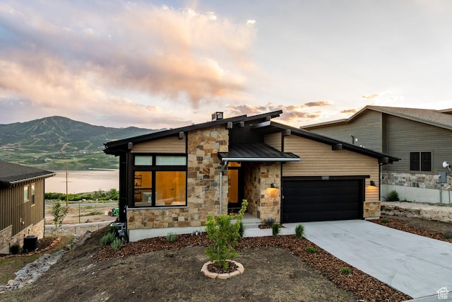 11795 N Star Gazer Cir, Hideout, UT 84036 - contemporary house featuring stone siding, an attached garage, concrete driveway, and a mountain view